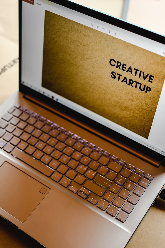 gallery-1 Laptop displaying 'Creative Startup' concept in an inspiring workspace.